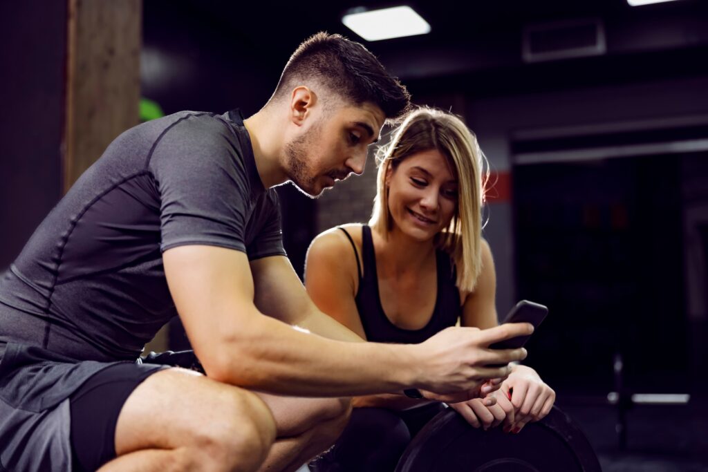 Gym members looking at review request on phone
