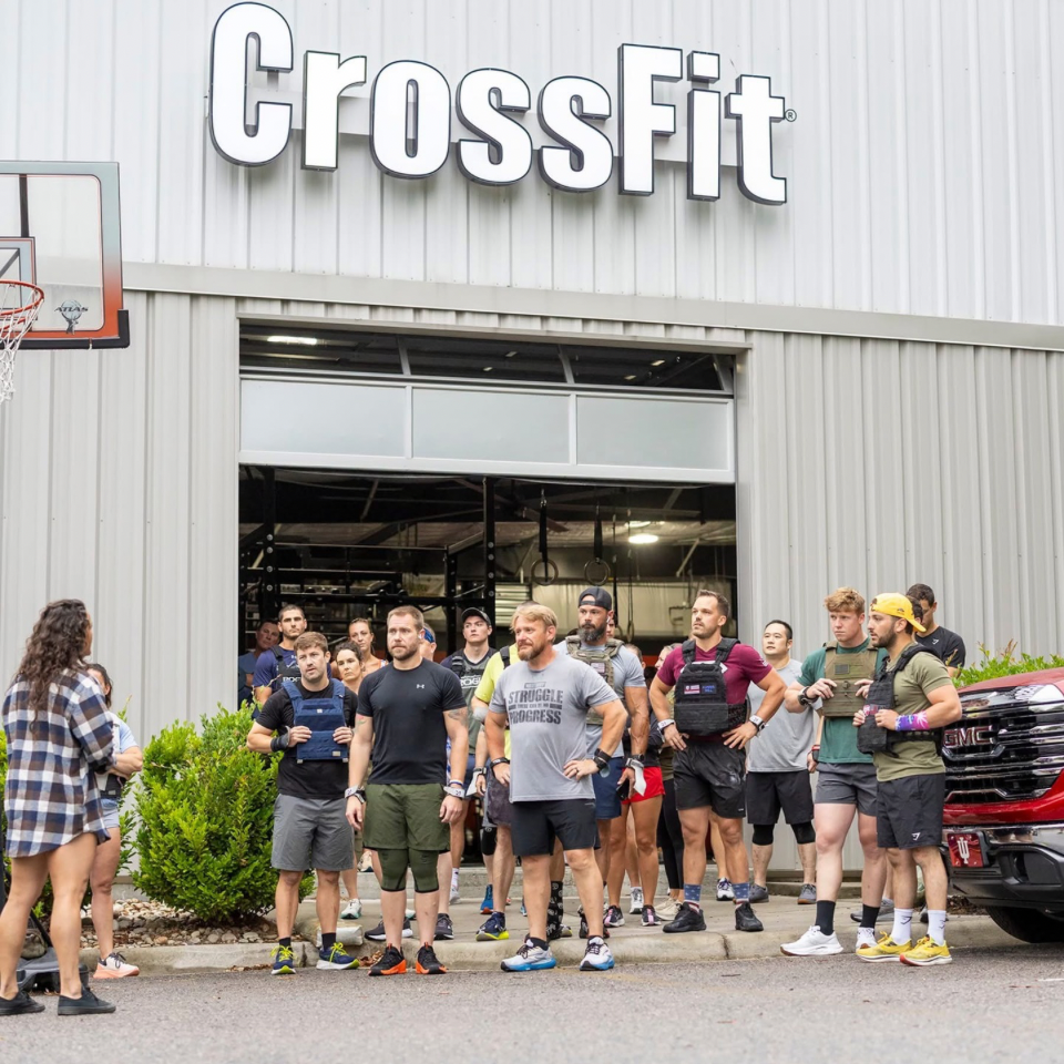 Members gather outside a CrossFit gym, preparing for a workout.